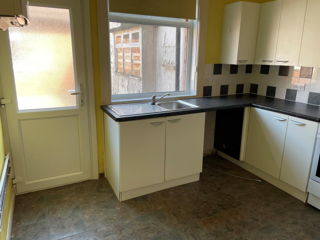 Lot: 139 - RETAIL UNIT AND WORKSHOP WITH GARAGE AND TWO FLATS - Kitchen on ground floor with access to courtyard